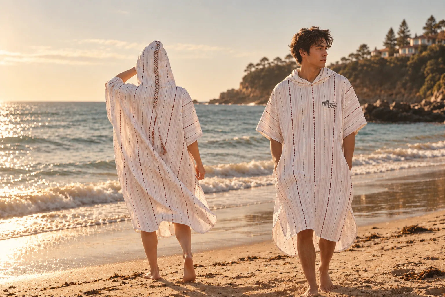Two people wearing Cuttle Hoods by the water